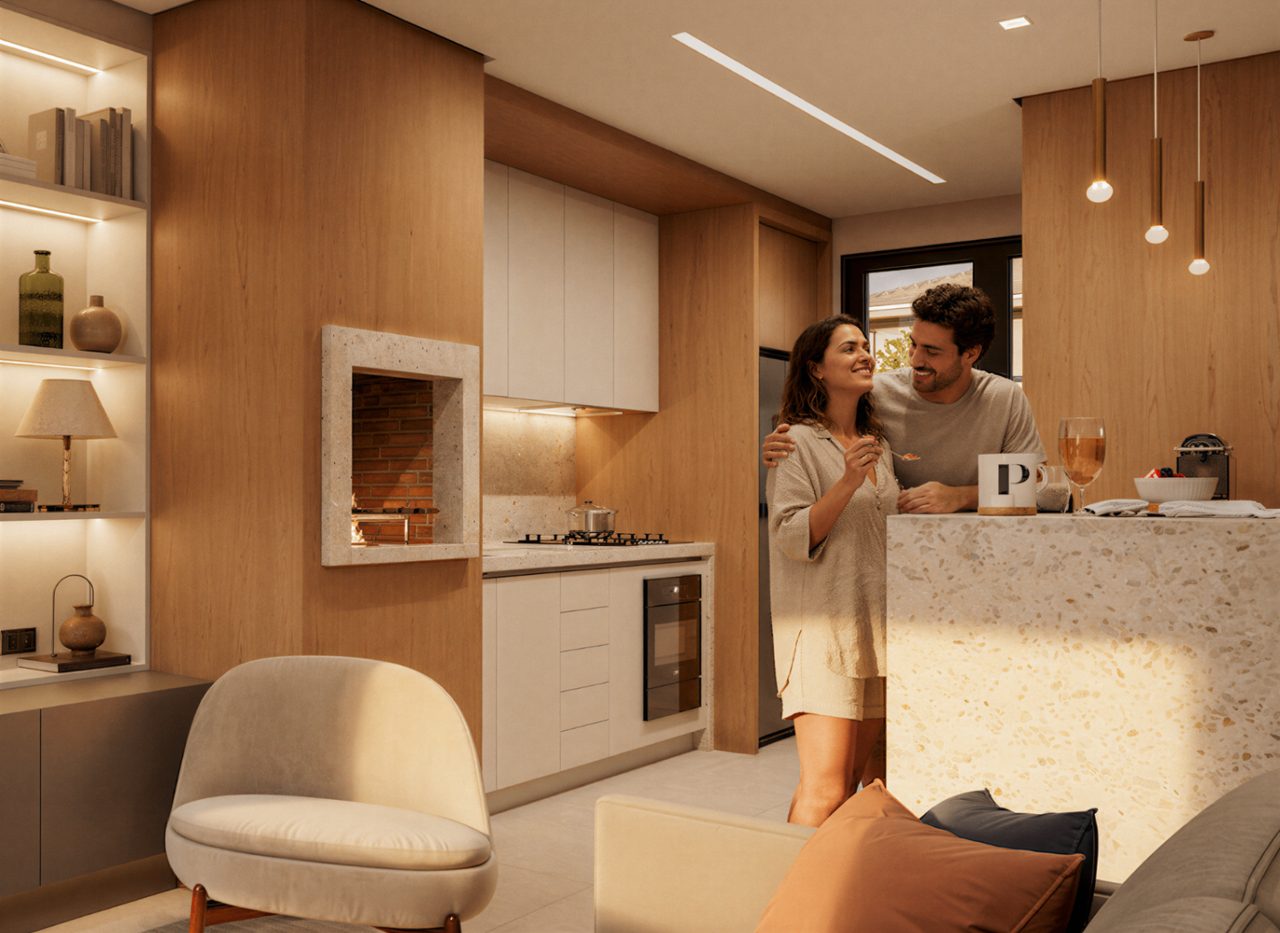 Casal em cozinha integrada ao living do Alameda18, com acabamento em madeira e iluminação natural